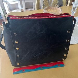 Social Threads and Living in Yellow collab gold-studded black cross body bag.